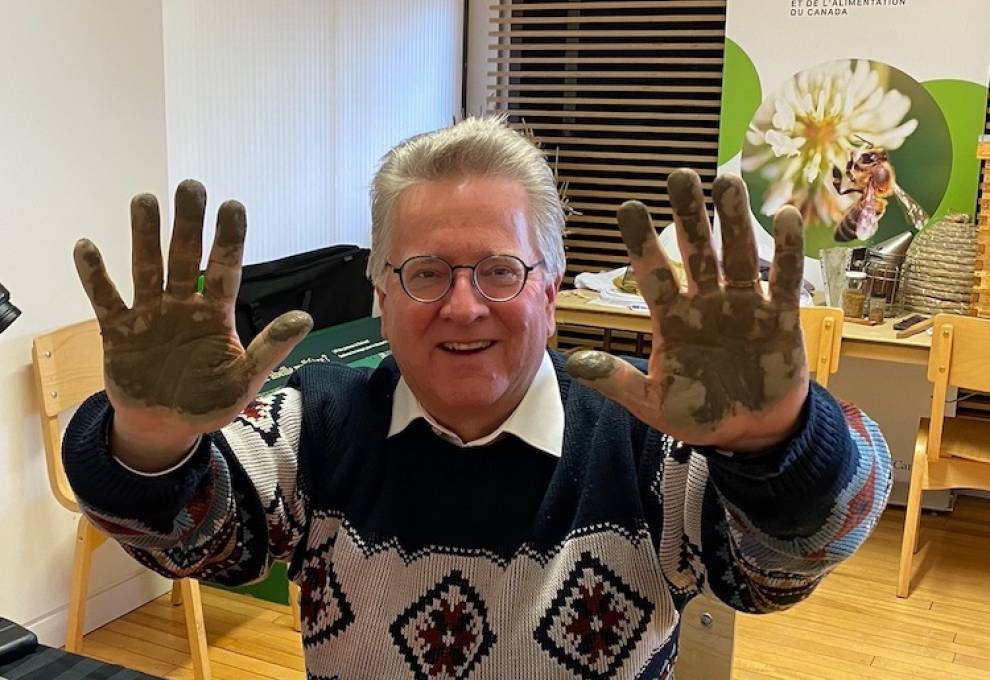 Senator Rob Black gets his hands dirty while learning about soil health at the Agriculture and Food Museum in Ottawa, Ontario in December 2022.