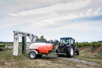 Tractor and spraying machine