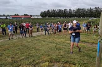 The capacity crowd was split into three groups for in-orchard tours at Archibald’s Orchards and Winery, Clarington, Ontario. In this photo, Ontario tree fruit specialist Erika DeBrouwer talks about trials with the pollen tube growth model. 